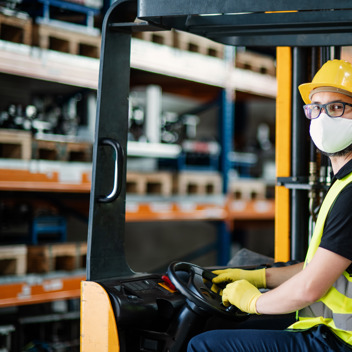 Forklift Driver in Face Mask in a warehouse