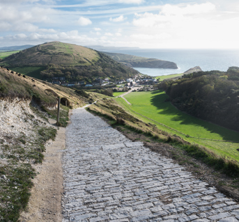 Cobble path through English Countryside heading to town