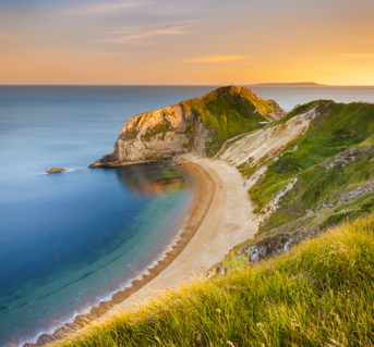 Jurassic Coast Beach pictured from cliffside at sunset